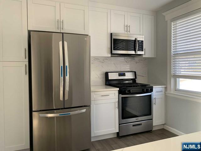 487 Summit Avenue, Unit 2 Fort Lee, NJ 07024 - Photo 6 of 17 a metallic refrigerator freezer sitting in a kitchen