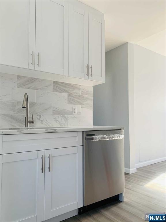 487 Summit Avenue, Unit 2 Fort Lee, NJ 07024 - Photo 9 of 17 a kitchen with granite countertop white cabinets and white appliances