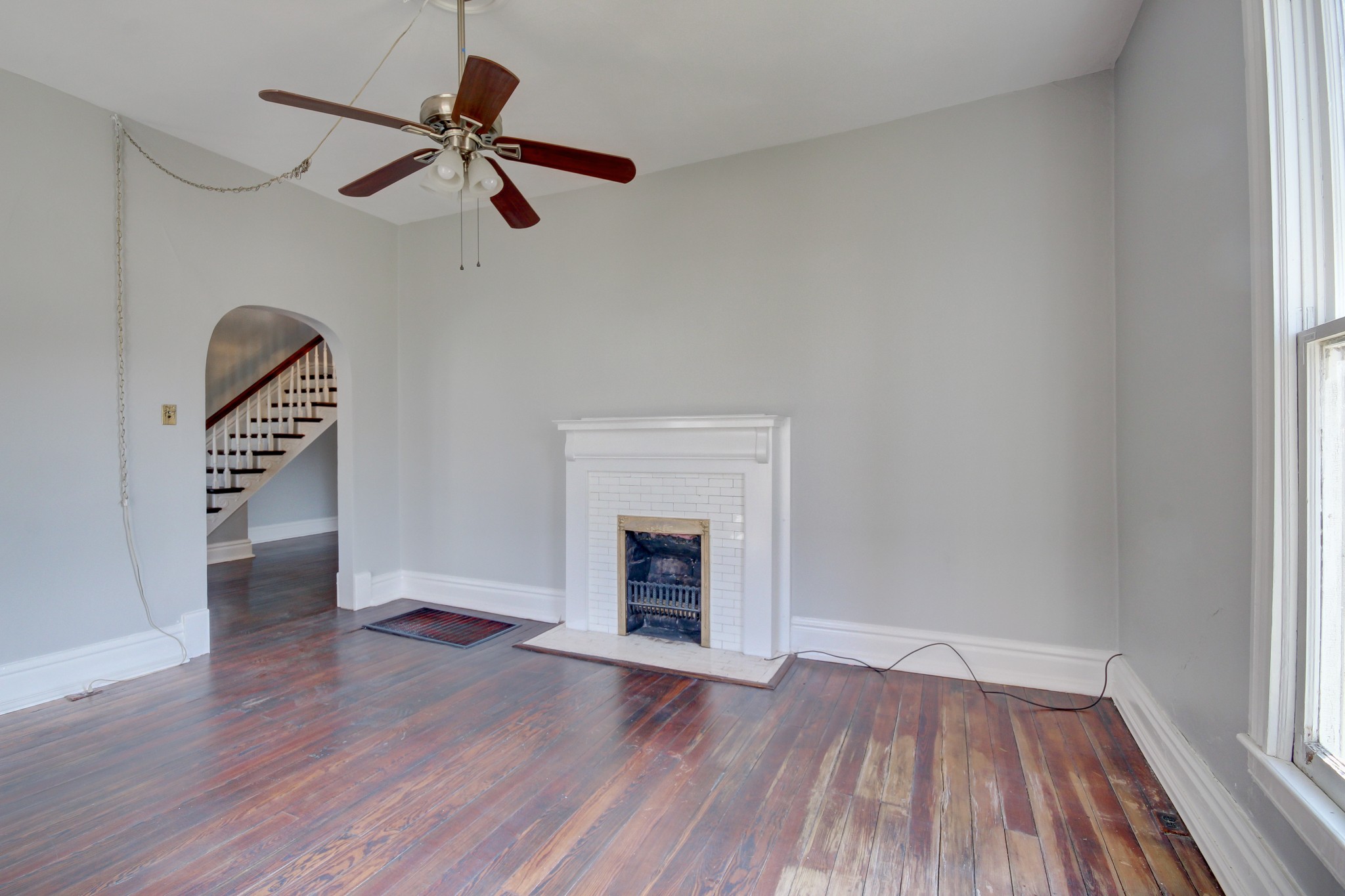 389 3rd Street Guthrie, KY 42234 - Photo 17 of 69 an empty room with wooden floor fireplace and windows