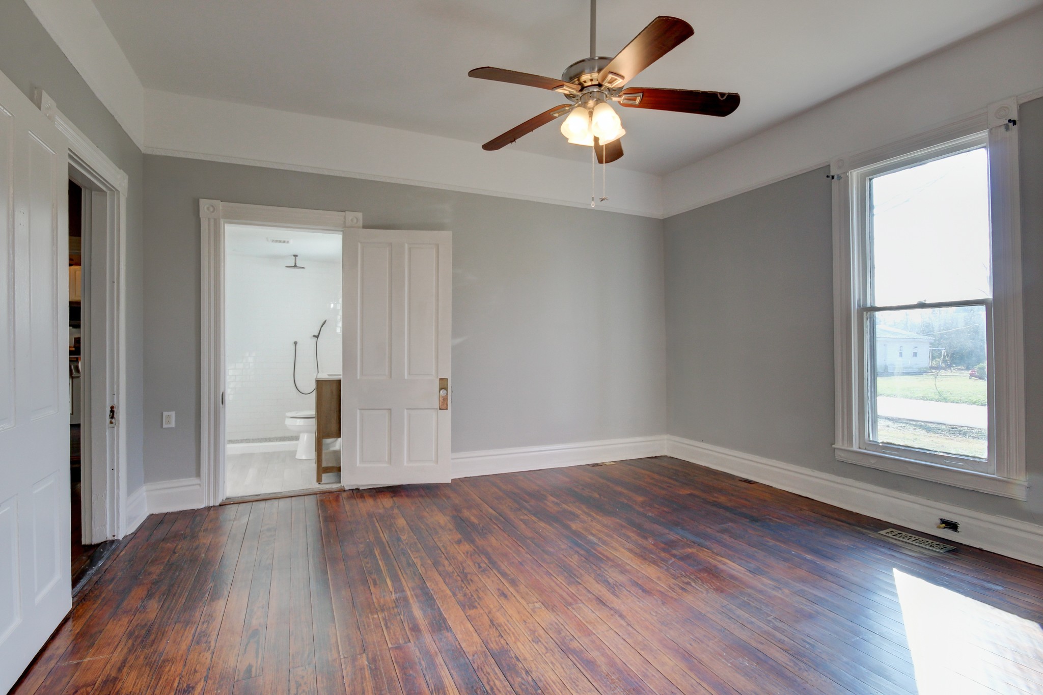 389 3rd Street Guthrie, KY 42234 - Photo 29 of 69 an empty room with wooden floor chandelier fan and windows