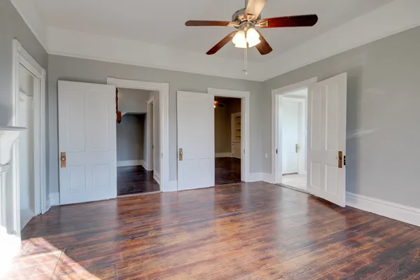 wooden floor in an empty room with a window