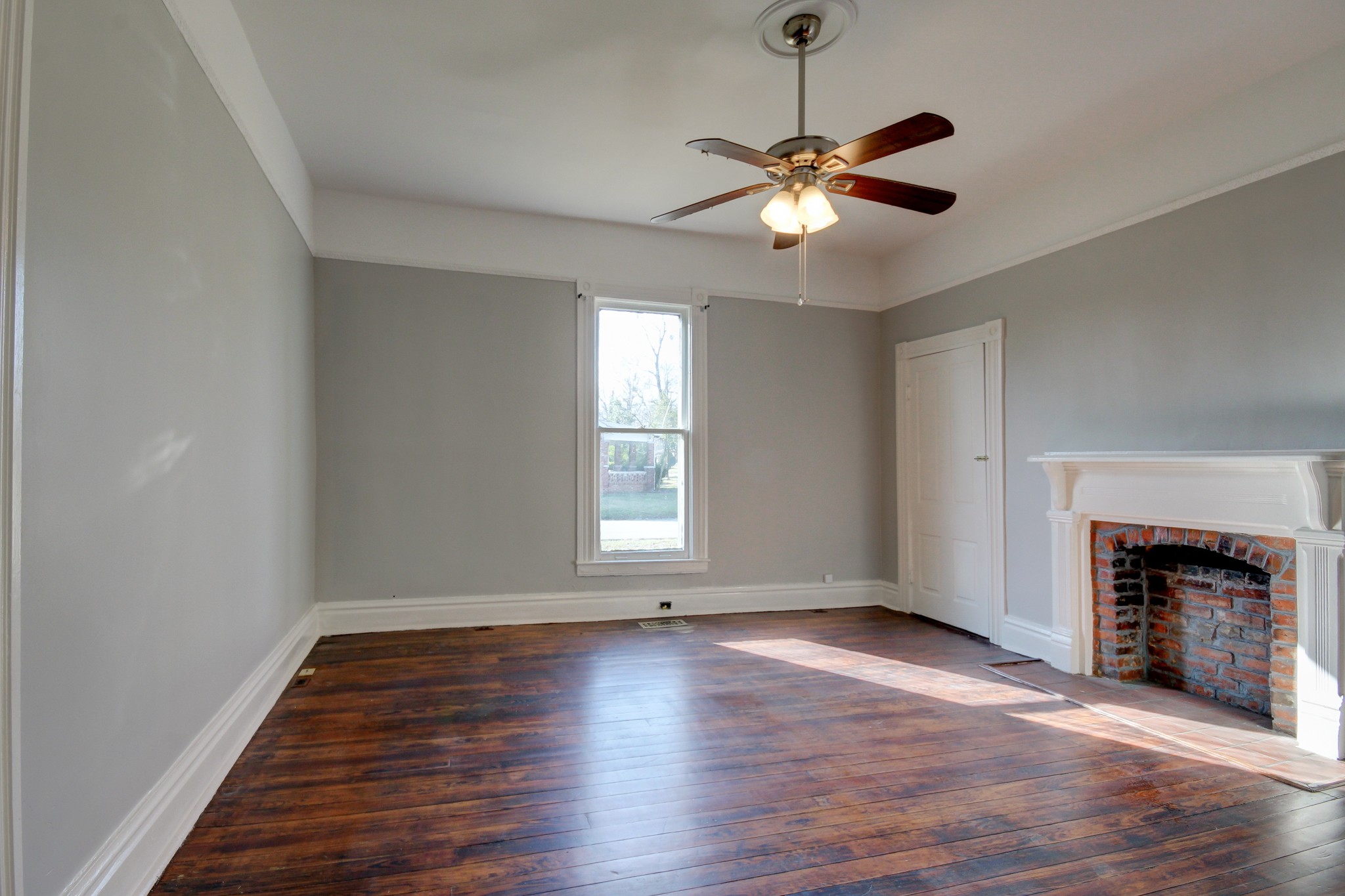 389 3rd Street Guthrie, KY 42234 - Photo 31 of 69 a view of empty room with wooden floor fireplace and window