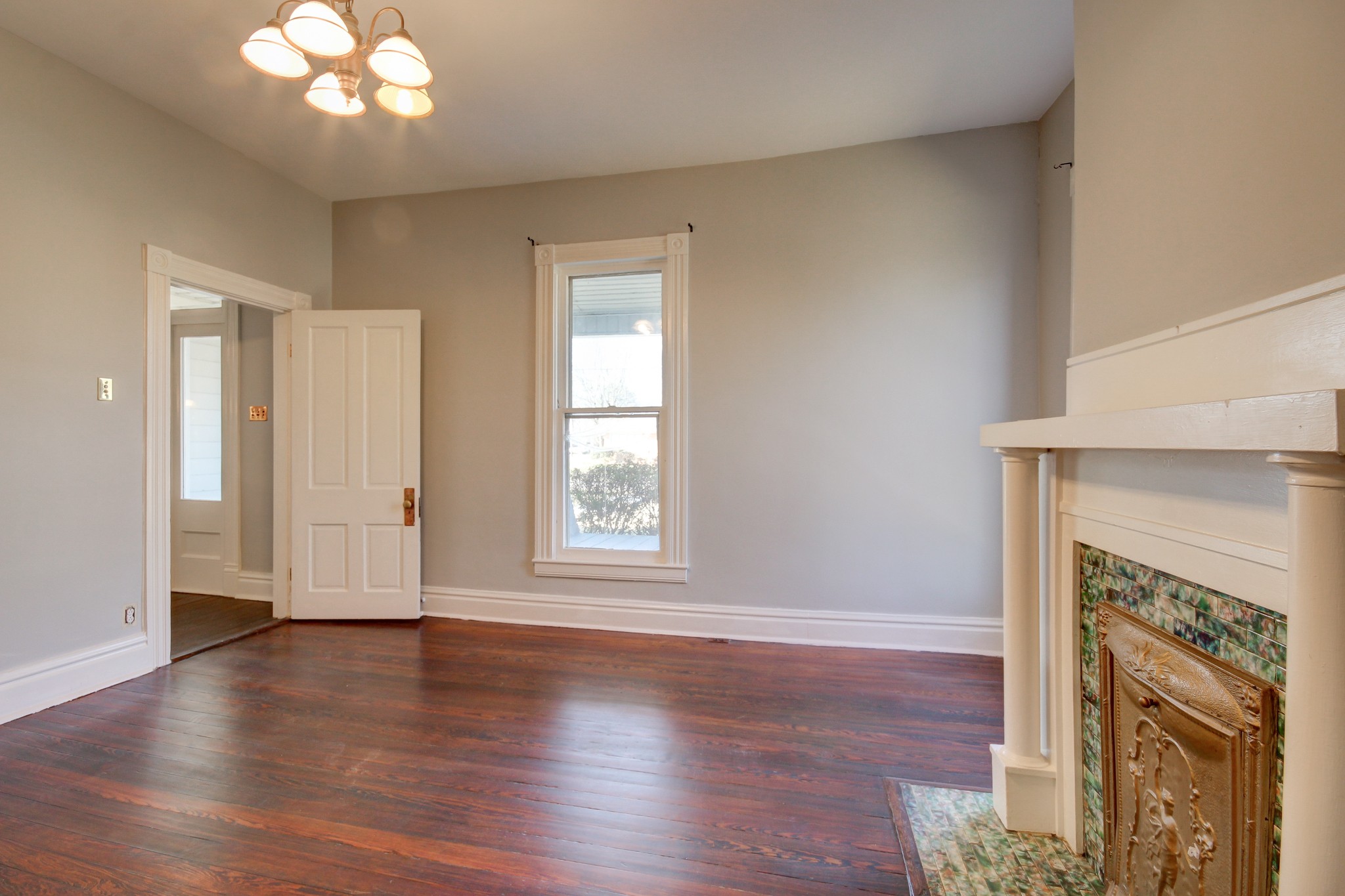 389 3rd Street Guthrie, KY 42234 - Photo 38 of 69 an empty room with wooden floor fireplace and windows