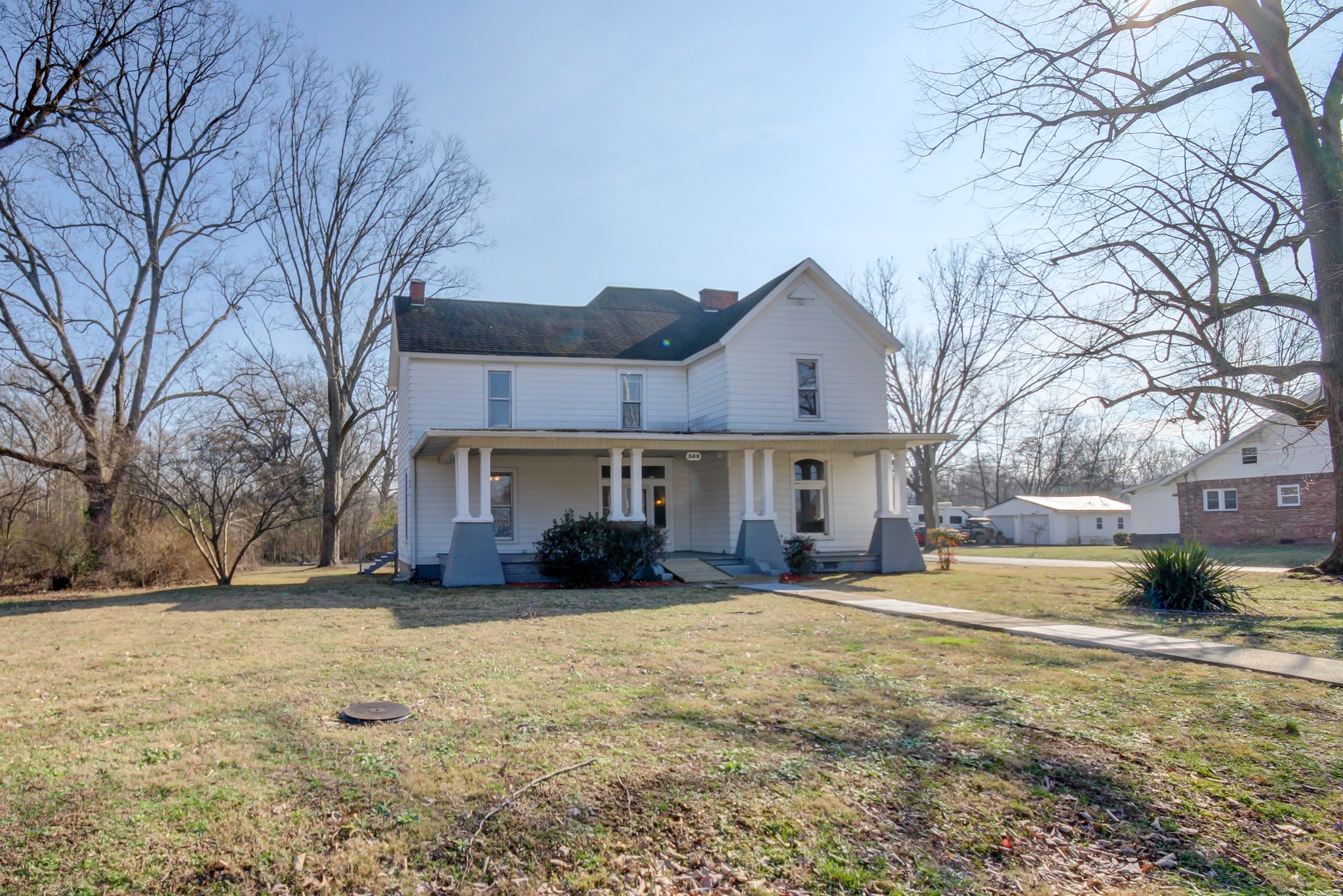 389 3rd Street Guthrie, KY 42234 - Photo 4 of 69 a view of a house with a yard covered in snow