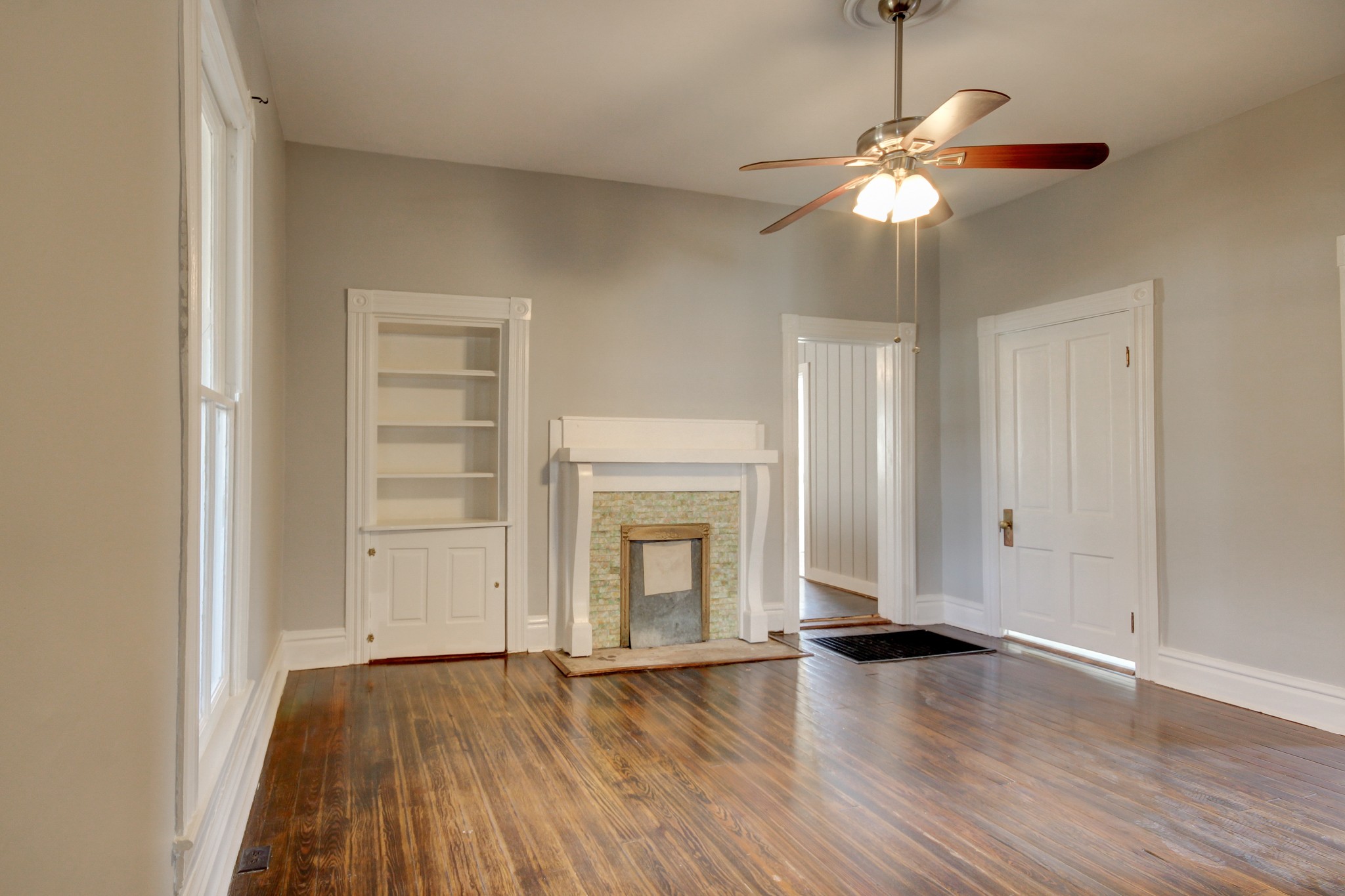 389 3rd Street Guthrie, KY 42234 - Photo 42 of 69 an empty room with wooden floor chandelier and windows