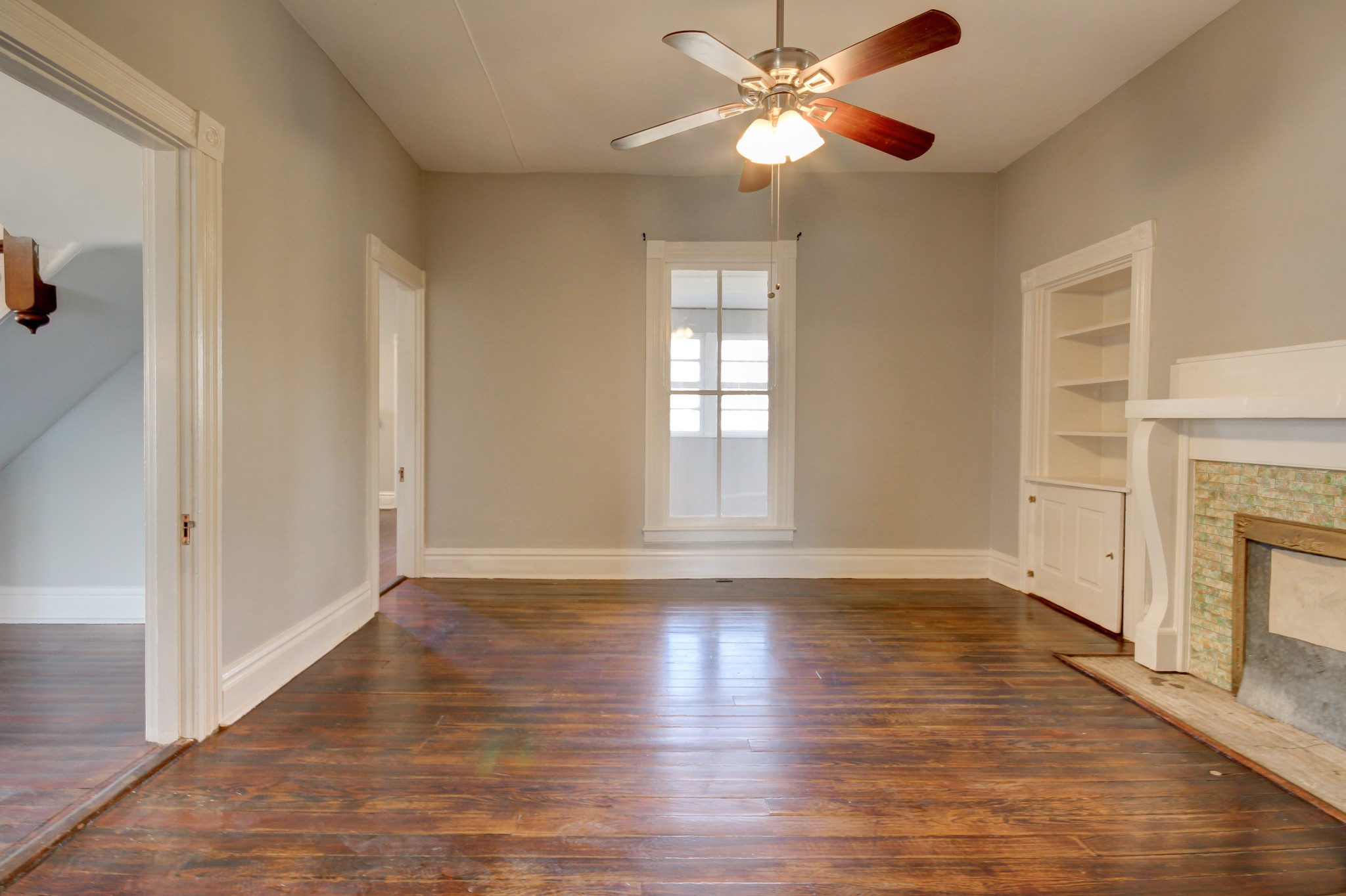 389 3rd Street Guthrie, KY 42234 - Photo 44 of 69 a view of an empty room with chandelier fan and wooden floor