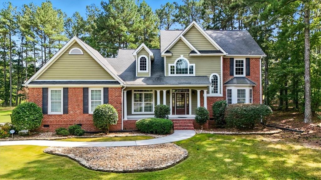 a front view of a house with garden