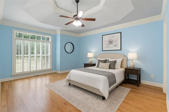 a spacious bedroom with a bed and a large window