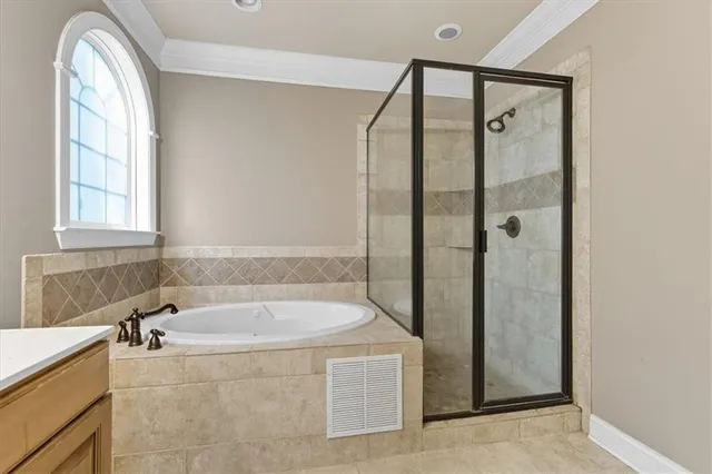 a bathroom with a granite countertop tub shower and sink
