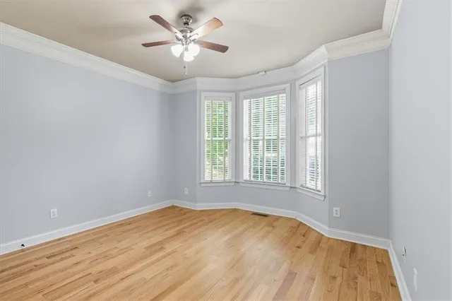 wooden floor in an empty room with a window