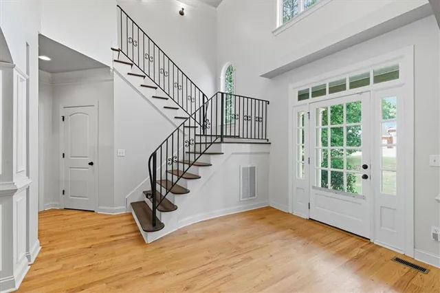 a view of an entryway with wooden floor and door