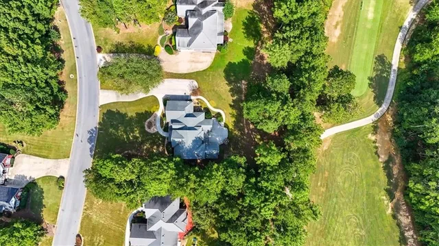 an aerial view of a house with a yard basket ball court and outdoor seating