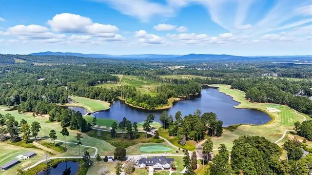 a view of a city with lots of residential buildings ocean and mountain view in back