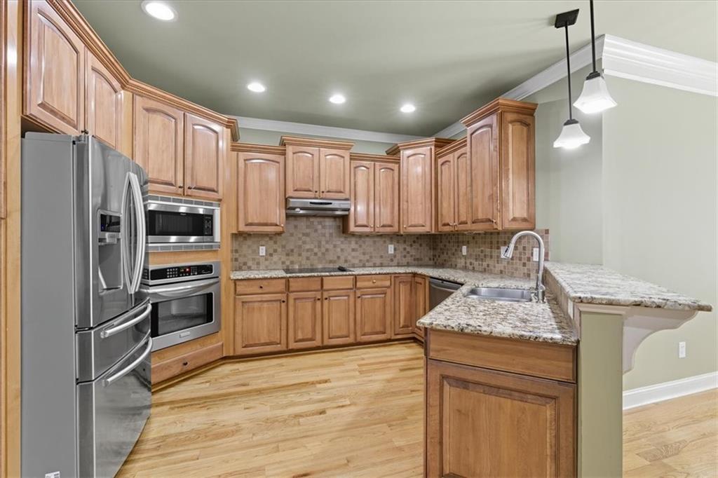 16 Nelson Boulevard Northwest Rome, GA 30165 - Photo 6 of 43 a kitchen with granite countertop stainless steel appliances and wooden cabinets