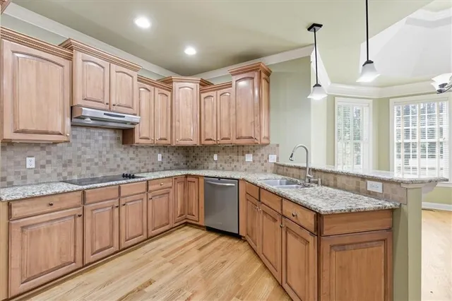 a kitchen with stainless steel appliances granite countertop a sink and cabinets