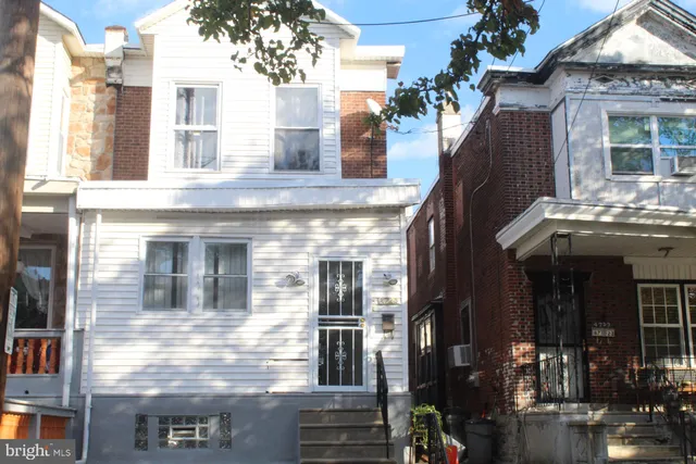 a view of a building with a tree front of house