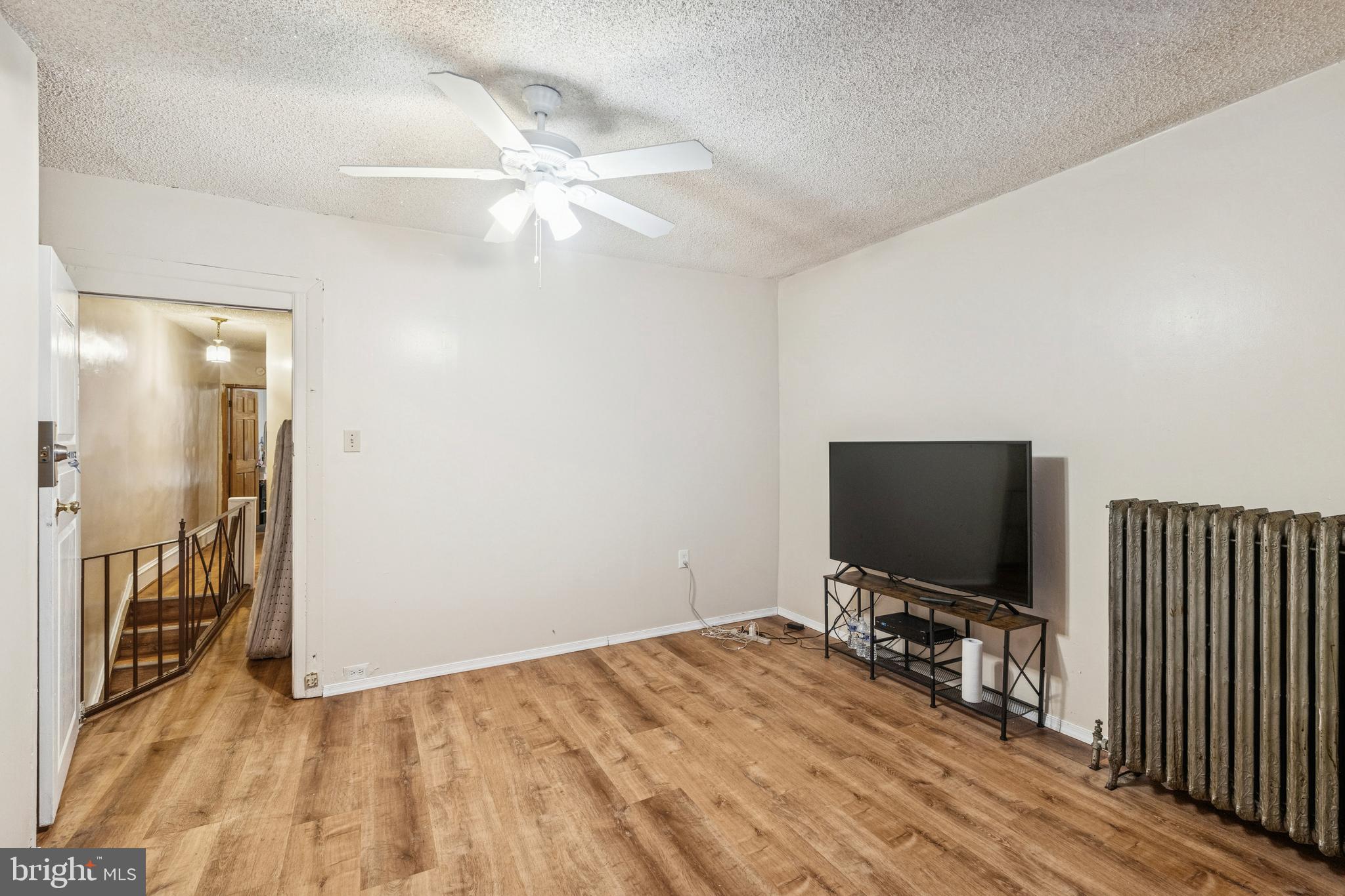 4725 Rosehill Street Philadelphia, PA 19120 - Photo 12 of 26 a room with a bed and a flat screen tv