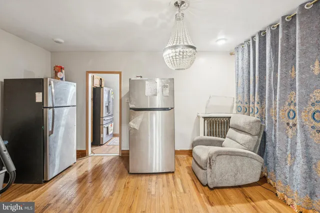 a view of living room and kitchen with furniture wooden floor and windows