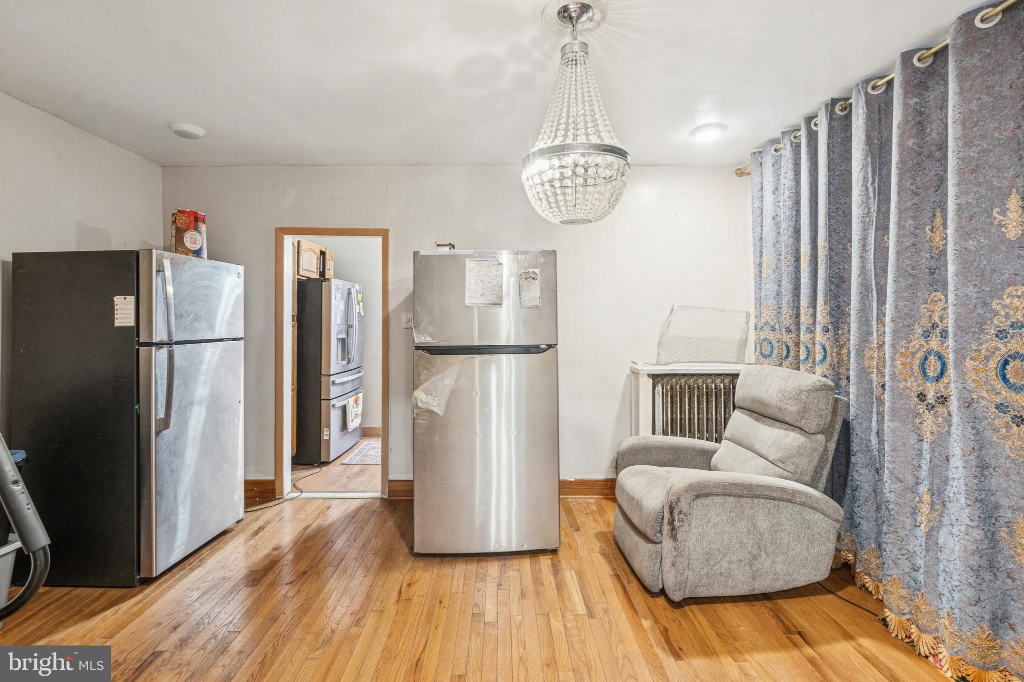 4725 Rosehill Street Philadelphia, PA 19120 - Photo 16 of 26 a view of living room and kitchen with furniture wooden floor and windows