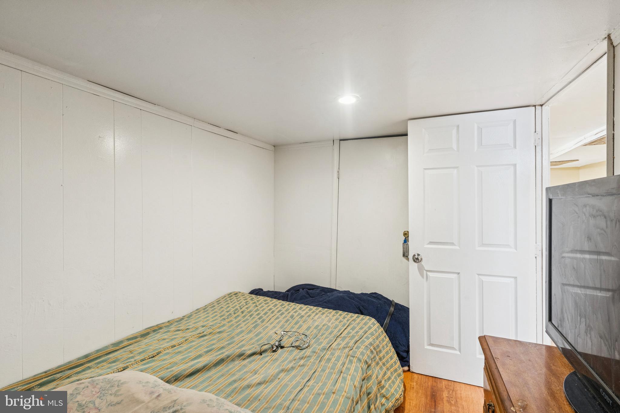 4725 Rosehill Street Philadelphia, PA 19120 - Photo 19 of 26 a bedroom with a bed and a chair