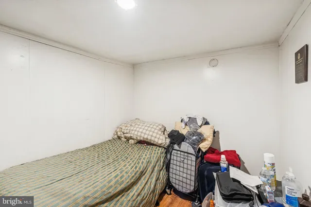 a room with a bed and wooden floor