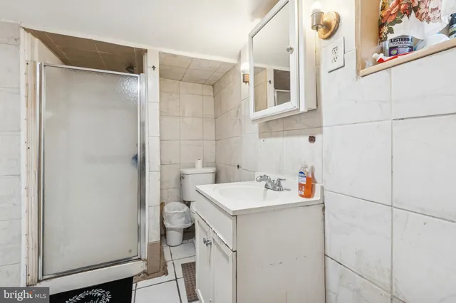 a bathroom with a sink and mirror with toilet