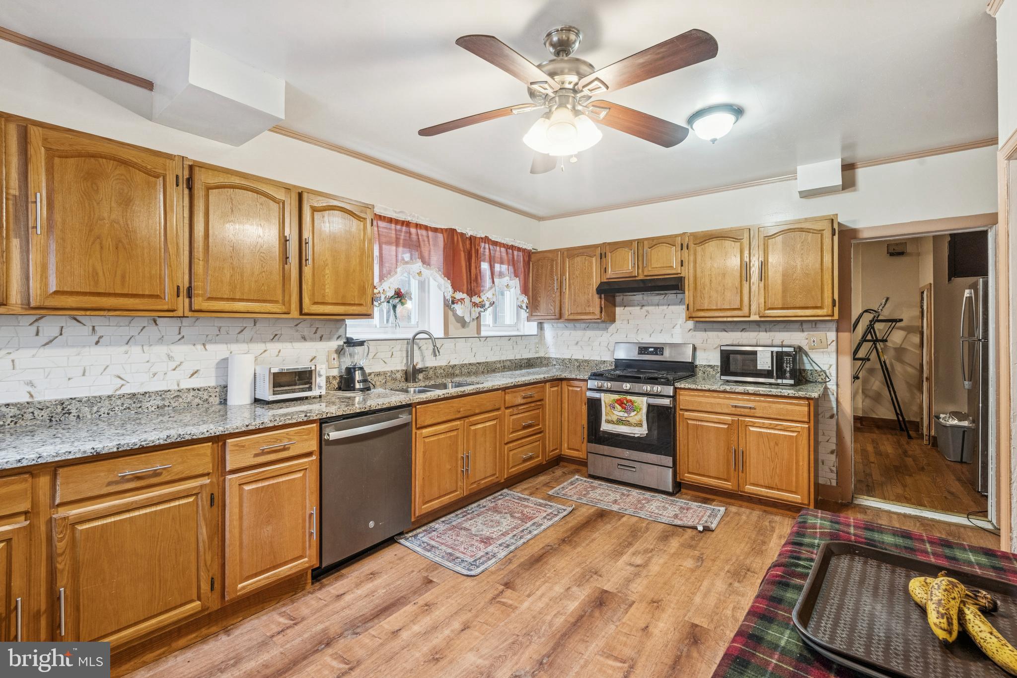 4725 Rosehill Street Philadelphia, PA 19120 - Photo 25 of 26 a kitchen with granite countertop appliances cabinets and a sink