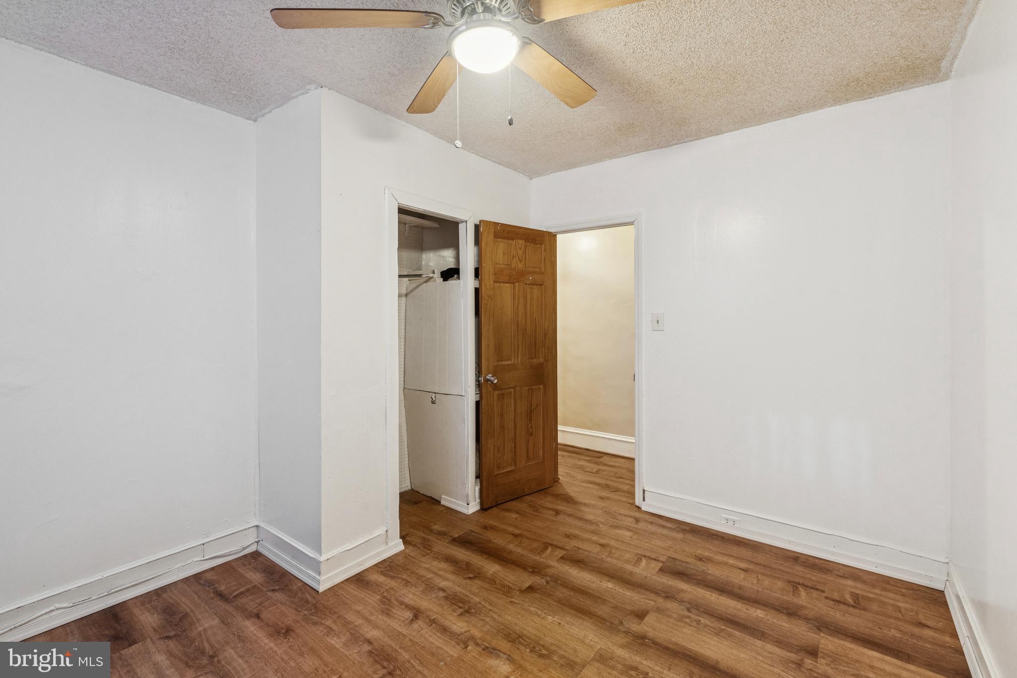 4725 Rosehill Street Philadelphia, PA 19120 - Photo 4 of 26 an empty room with wooden floor and ceiling fan