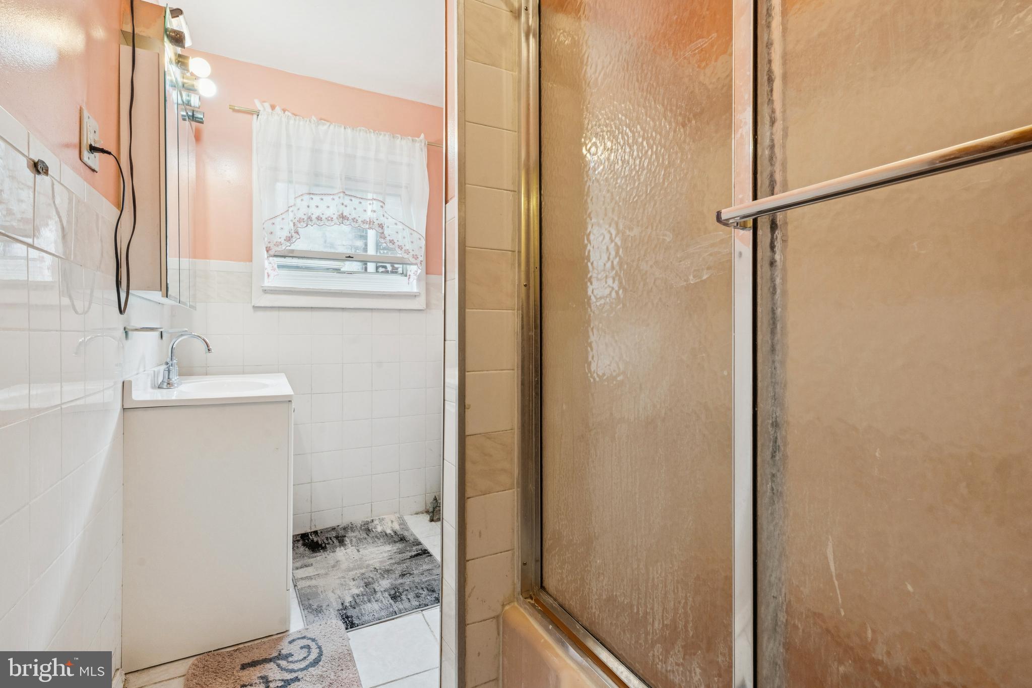 4725 Rosehill Street Philadelphia, PA 19120 - Photo 7 of 26 a bathroom with a sink and a mirror