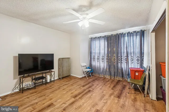 a bedroom with furniture and a flat screen tv