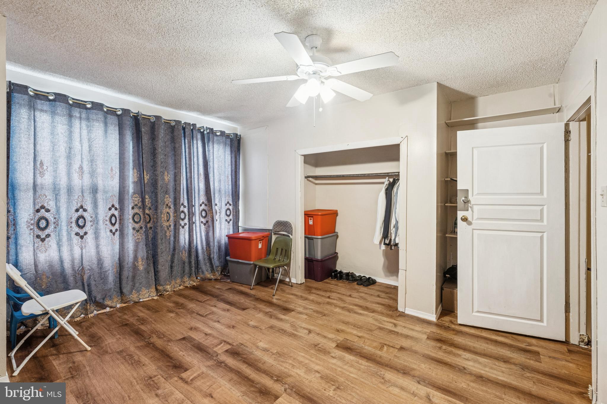 4725 Rosehill Street Philadelphia, PA 19120 - Photo 10 of 26 a bedroom with a bed and a chandelier