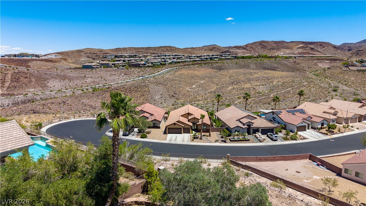 2256 Dogwood Ranch Avenue Henderson, NV 89052 - Photo 9 of 51 Perched on a hillside, this residence offers an elevated perspective of the surrounding desert landscape and community.