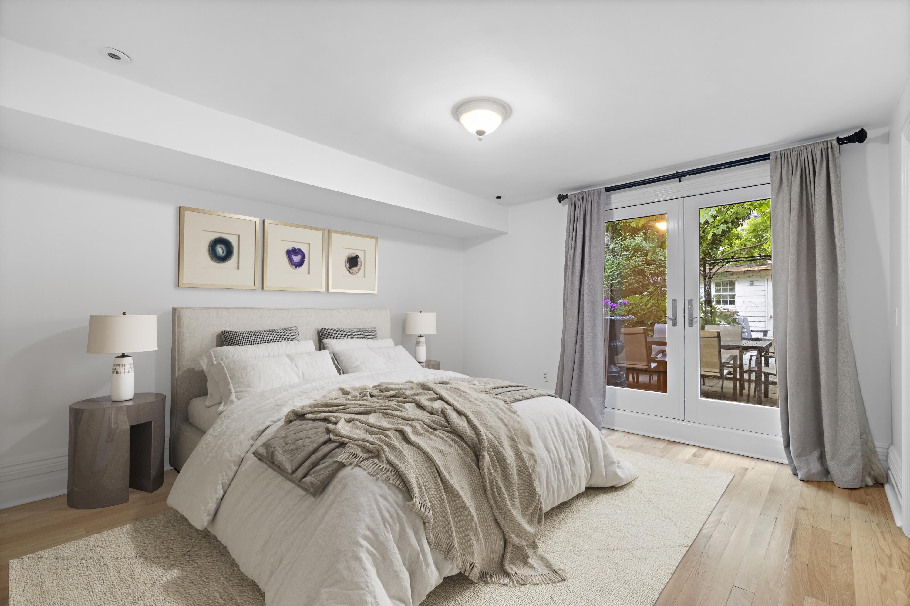 720 Bloomfield Street, Unit 1 Hoboken, NJ 07030 - Photo 6 of 13 a bedroom with a bed and a large window