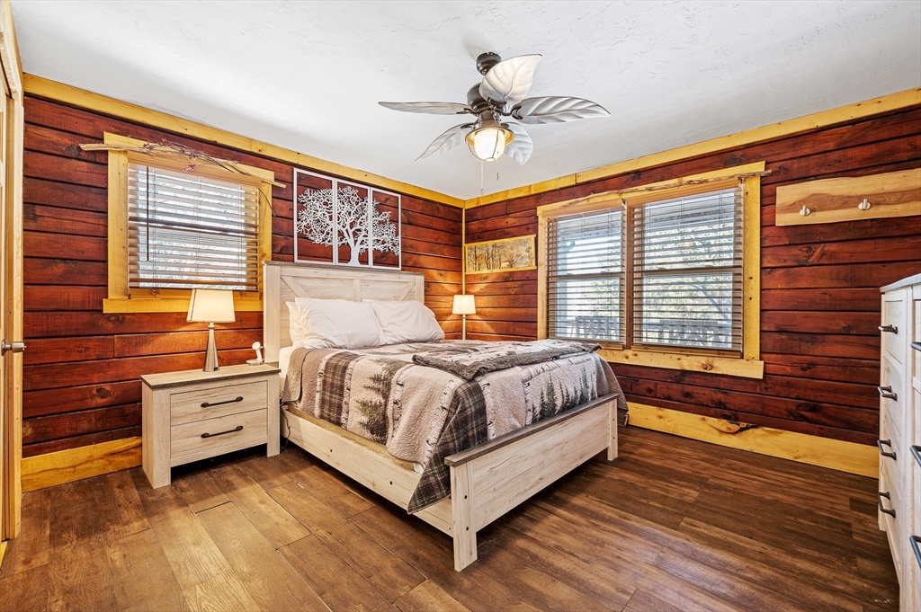 76 Wheeler Road Princeton, MA 01541 - Photo 12 of 42 a bedroom with a large bed and a chandelier