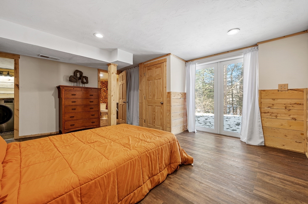 76 Wheeler Road Princeton, MA 01541 - Photo 16 of 42 a spacious bedroom with a bed and wooden floor