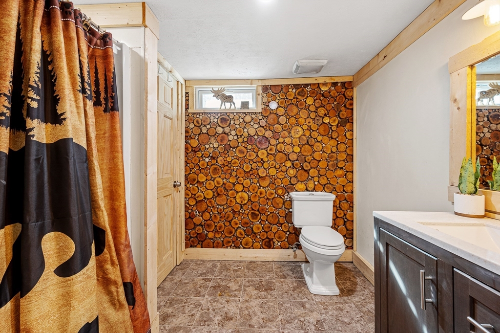 76 Wheeler Road Princeton, MA 01541 - Photo 19 of 42 a bathroom with a toilet sink and shower curtain