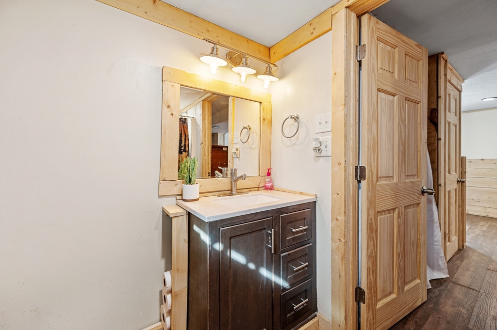 76 Wheeler Road Princeton, MA 01541 - Photo 20 of 42 a bathroom with a granite countertop sink a mirror and a shower