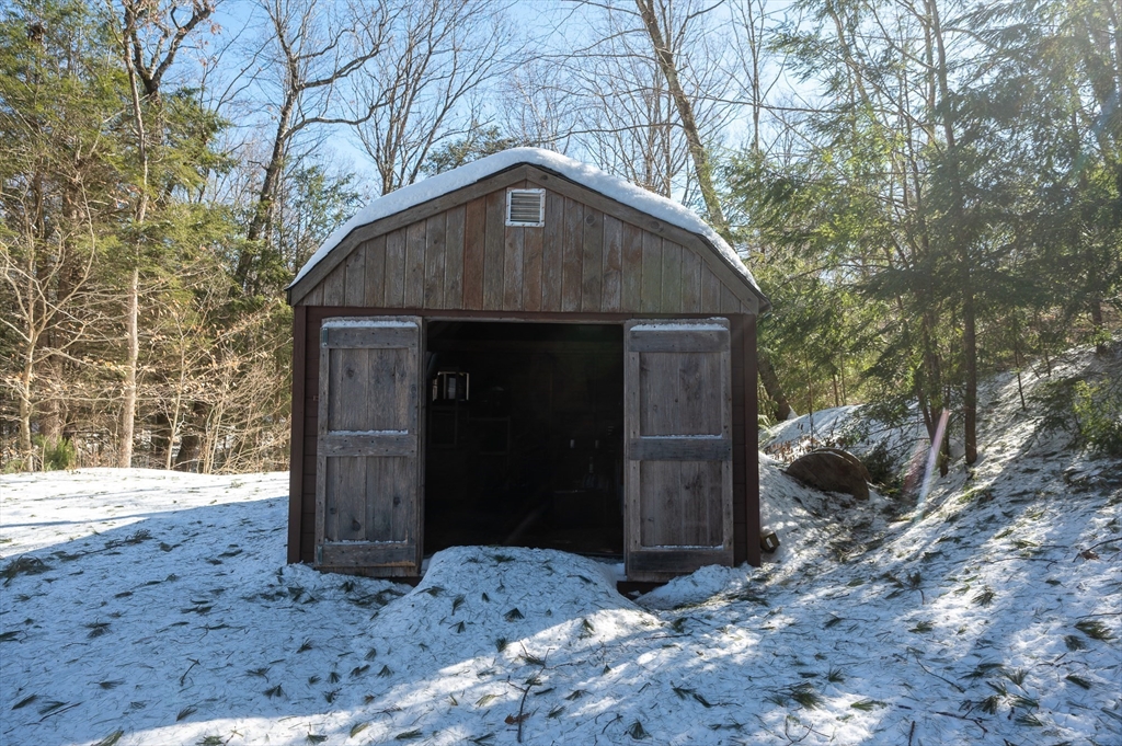 76 Wheeler Road Princeton, MA 01541 - Photo 33 of 42 a wooden house with trees in the background