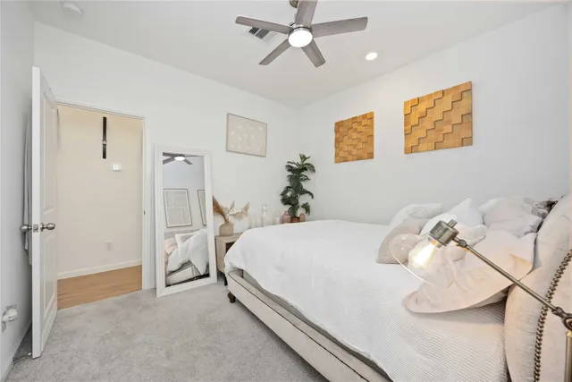 a bedroom with a bed and ceiling fan