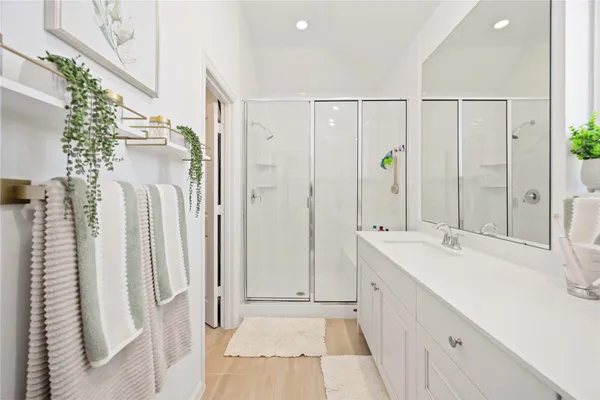 a bathroom with a double vanity sink and mirror