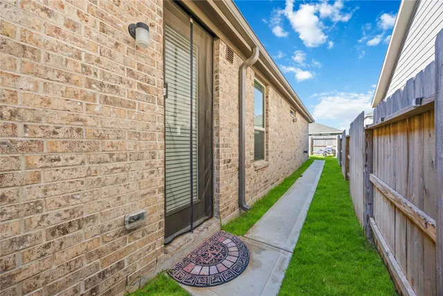 a view of a porch with furniture and a yard