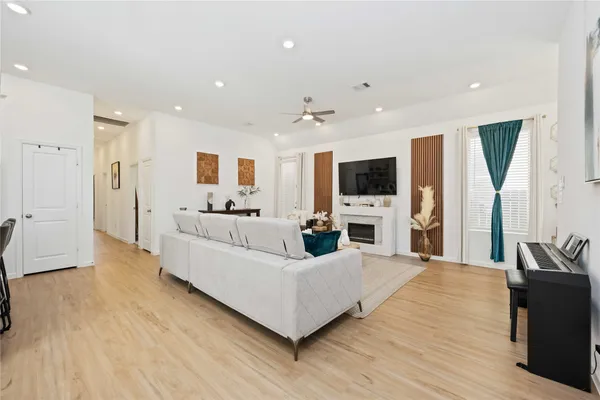 a living room with furniture a flat screen tv and a fireplace