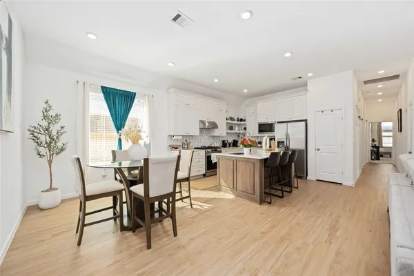 a view of a dining room with furniture and a wooden floor