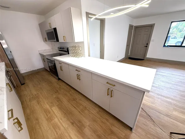 a spacious bathroom with a sink a mirror and a bathtub