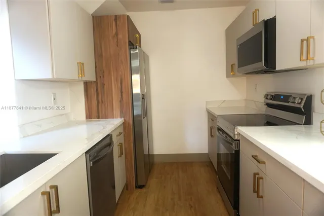 a kitchen with a sink stove and microwave