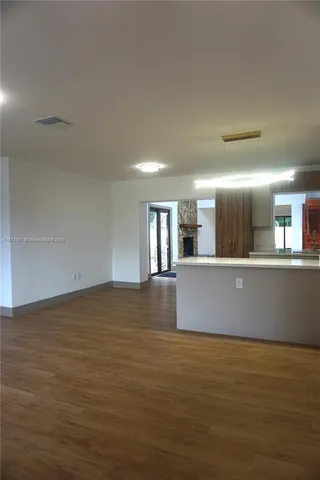 a view of kitchen and empty room