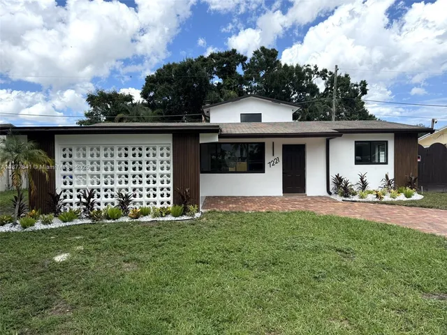 a front view of a house with yard and porch