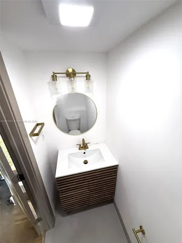 a bathroom with a sink and mirror