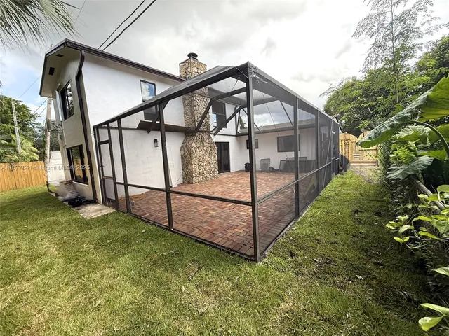 a view of a house with wooden fence