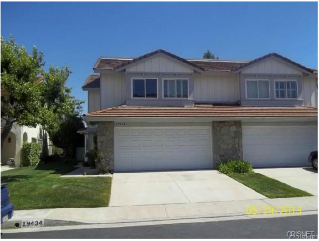 19434 Crystal Ridge Lane Porter Ranch, CA 91326 - Photo 1 of 1 a view of a white house with a yard and large tree